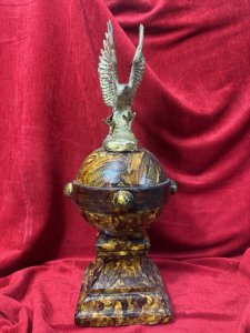Antique Georgian cast iron table centrepiece, circa 1800, featuring a stooping eagle atop a globe and obelisk with a scumbled painted finish. A large, heavy decorative piece. Dimensions: 53 cm high, obelisk width 21 cm, with a 21 cm square base. For further information, please call the museum curator on 07707 488566.