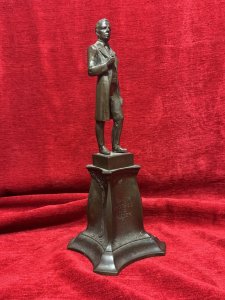 Solid bronze sculpture of U.S. President Abraham Lincoln, titled 'The Emancipator', mounted on an ornate pedestal decorated with floral sprays. Described as originally sculpted by George Edwin Bissell (1839–1920) and cast by the Gotham Foundry. The front of the pedestal bears the inscription 'Power Progress and Freedom'. The reverse is dated 1902 and inscribed 'What I Have Said, I Have Said. I Withdraw Nothing.' Dimensions: 35 cm high × 13 cm wide.