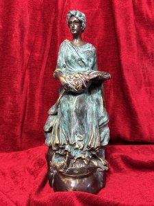 French bronze sculpture of a fruit-bearing goddess, circa 1920. The figure wears a gown with a green verdigris finish. Dimensions: 33 cm high × 15 cm wide × 14 cm deep.