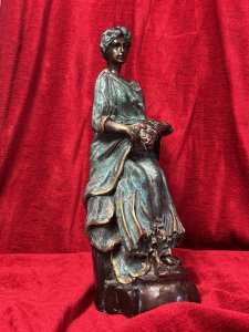 French bronze sculpture of a fruit-bearing goddess, circa 1920. The figure wears a gown with a green verdigris finish. Dimensions: 33 cm high × 15 cm wide × 14 cm deep.