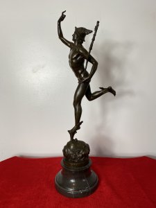 Fine Bronze Romanesque Sculpture Statue Of Hermes After Giambologna On Marble Plinth Signed. Circa - Late 19th Century Composition- Bronze A Fine & Exceptionally Executed Sculptured Bronze Statue Hermes Belvedere Beautifully Posed Holding A Mace With Talaria (Winged Shoes) And Helmet. Stands Upon A Child’s Fountain Head. Hermes Was Notoriously Messenger To The Gods. Stamped And Signed On The Base And Set On Stepped Curricular Black Marble Plinth. Grand Tour Style Object Of Virtue. Signed G . da Bologna No A7255 Stamped Paris Medallion - BRONZE GARANTI PARIS J B DEPOSEE Dimensions In Inches Height 23” Base Diameter 6”