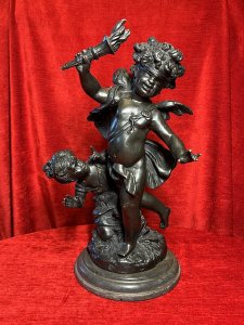 Bronze Sculpture Of Blind Folded Eros With Young Psykhe After Auguste Moreau Circa - 1890 Composition - Bronze Brief History Of Sculptor Auguste Moreau 1834-1917 Paris Born Moreau Was The Youngest Of Three Brothers Born Of Sculptor Jean-Baptiste Moreau. His Figurative Sculptures Are Highly Renowned For Their Quality, Realism And Beauty. In 1861 Auguste Made His debut At The Salon Where He Exhibited Regularly Until 1913. His Is Best Known For Subjects Of Allegorical Scenes Including Cupids And Young Children As Well As Birds And Sensuously Clad Young Maidens. Listing Description Wonderful French Myological Bronze Sculpture Showpiece After Auguste Moreau Of Winged Eros As Cupid God Of Love, Portrayed Acting Blindly So His Eyes Are Covered With A Blindfold As He Wields The Flame of Love (Lit Torcher) In Right Arm. Young Psykhe Kneeling Waving (Left Side) To Eros Wondering Why She Cannot Been Seen By Him. Fine Quality Figures In Exception Detail With Original Rich Patina. Both Figures Set Upon Circular Plinth Of Abundant Grasses And Foliage With Black Marble Stepped Pediment. Provenance Part Of Lord Hill Museum Private Collection Dimensions In Inches Height 17" Width 9" Base Diam 8"