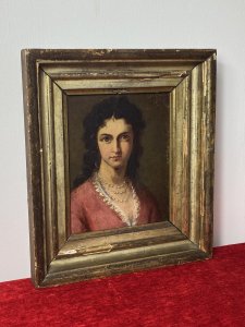Late 19C Oil Portrait Of Lady Wearing Pearl Necklace Signed By Artist J Axmann. Circa - 1866 Composition- Oil On Board Front Facing Head And Shoulder Portrait Of Unknown Angelic Lady Sitter With Dark Hair, Hazel Eyes And Pronounced Facial Features. Wears Pink Gown Decorated With Eyelash Lace Detail And Eye Catching Three String Pearl Necklace. Exceptional Detailed Portrait By Very Accomplished And Well Known Artist J Axmann. Signed Top Right Corner By Artist And Set In Gilt Wood Frame. The Frame Showing Signs Of Wear Due To Age. Dimensions In Inches Height 11.5” Width 9 3/4”