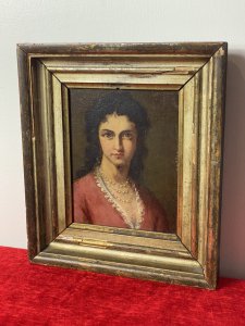 Late 19C Oil Portrait Of Lady Wearing Pearl Necklace Signed By Artist J Axmann. Circa - 1866 Composition- Oil On Board Front Facing Head And Shoulder Portrait Of Unknown Angelic Lady Sitter With Dark Hair, Hazel Eyes And Pronounced Facial Features. Wears Pink Gown Decorated With Eyelash Lace Detail And Eye Catching Three String Pearl Necklace. Exceptional Detailed Portrait By Very Accomplished And Well Known Artist J Axmann. Signed Top Right Corner By Artist And Set In Gilt Wood Frame. The Frame Showing Signs Of Wear Due To Age. Dimensions In Inches Height 11.5” Width 9 3/4”