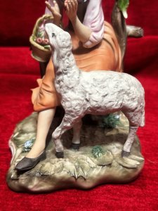 Capodimonte Porcelain Tale Of Boo Peep Figurine Circa- Vintage Composition - Hard Paste Porcelain. Listing Description Young Maiden Sitting On Picket Fence With Basket Of Apples And Lamb Companion Gazing Up For Apple Reward. Finely Detailed Porcelain Charming Subject. Dimensions In Cms Height 20cm X Width 14cm X Depth 15cm