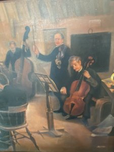 String Quartet Interior Scene Oil On Canvas Signed By Artist L Barnes. Circa - 1900 Composition- Oil On Canvas Stunning Orchestration Of A Four String Quartet Set In Traditional Oak Beamed Interior Scene. A Violinist Looks Straight At The Artist, Whilst The Two Base Players Sit Immersed Reading Sheet Music. The Second Violinist Sits Away From the Artist Towards A Well Illuminated Window. Beautiful Impressionistic Musical Scene With Exceptional Quality. Set In Solid Elmwood Frame & Signed By The Artist L Barnes. Provenance Exhibition At London Art Gallery And Purchased By The Lord Hill Private Museum. Dimensions In Inches Frame Height 24 3/4” X Width 28 3/4” Painting Height 19.5” X Width 23 1/4”