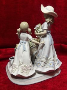 The Flower Harvest Porcelain Figurine By The Leonardo Collection Circa - Vintage Condition - Pristine Composition - Porcelain Listing Description Wonderfully Elegant Large Leonardo Collection Figurine Totle ‘The Flower Harvest’ Depicting A Mother And Daughter Picking Flowers From Decorative Flower Kart. Stamped On Base. Dimensions In Cms Height 26cm X Width22cm X Depth 22cm