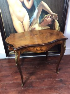Beautiful French Marquetry And Ormolu Mounted Serpentine Shaped Salon Table Louis XVI Style For Queen Of France Marie Antoinette Exceptional Walnut Table With Serpentine Shaped Top With Gadrooned Edge And Top Skirt. Marquetry Inlaid Oval Panels Displaying Floral Inlay Bouquets In Exotic Woods Including Olive Wood, Satinwood, Rosewood, Kingwood & Yew Wood. Original Condition Beautiful Elegant Ladies Piece Provenance From Paris Collector And Purchased By Lord Hill Museum 2010 Now Part Of Extensive Collection Dimensions In Inches Height 27” Width 34” Depth 21” Weight Approx 28Kg