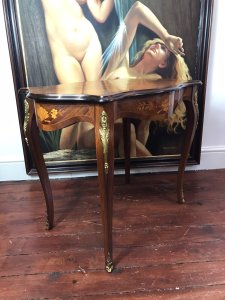 Beautiful French Marquetry And Ormolu Mounted Serpentine Shaped Salon Table Louis XVI Style For Queen Of France Marie Antoinette Exceptional Walnut Table With Serpentine Shaped Top With Gadrooned Edge And Top Skirt. Marquetry Inlaid Oval Panels Displaying Floral Inlay Bouquets In Exotic Woods Including Olive Wood, Satinwood, Rosewood, Kingwood & Yew Wood. Original Condition Beautiful Elegant Ladies Piece Provenance From Paris Collector And Purchased By Lord Hill Museum 2010 Now Part Of Extensive Collection Dimensions In Inches Height 27” Width 34” Depth 21” Weight Approx 28Kg