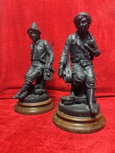 Cornelius & Baker Rare Pair Of Figural Statues The Organ Grinder & The Puppeteer Circa - Late 19th Century Composition - Cast Zinc Metal On Wood Plinth Bases Listing Description Pair of Rare Antique American Manufacturer Cornelius And Barker Figural Statues. The Statues Depict Street Musicians Specifically Titled 'The Organ Grinder' With A Monkey Under His Coat, And A Musician Holding A String Instrument With A Stringed Puppet Titled 'The Puppeteer'. Stunning Pair in Superb Detail And Wonderful Condition. Set Upon Solid Wood Cylindrical Plinth Bases. Dimensions In Inches Height 35cm X Width 19cm X Depth 17cm