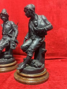 Cornelius & Baker Rare Pair Of Figural Statues The Organ Grinder & The Puppeteer Circa - Late 19th Century Composition - Cast Zinc Metal On Wood Plinth Bases Listing Description Pair of Rare Antique American Manufacturer Cornelius And Barker Figural Statues. The Statues Depict Street Musicians Specifically Titled 'The Organ Grinder' With A Monkey Under His Coat, And A Musician Holding A String Instrument With A Stringed Puppet Titled 'The Puppeteer'. Stunning Pair in Superb Detail And Wonderful Condition. Set Upon Solid Wood Cylindrical Plinth Bases. Dimensions In Inches Height 35cm X Width 19cm X Depth 17cm