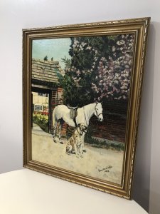 Vintage Original Oil Painting Titled Friends Dog With A Horse By Artist Eva Weelies. Medium - Oil Circa - 1970 Condition- Lovely Used Original Portrait Was A Postcard By Famous Dog Trainer Barbara Woodhouse. This Oil Painting Is A Interpretation From That Postcard Showing A Grey Horse And Dog Named Juno Standing In A Garden Of Beautiful Home Presumably Barbera Woodhouse’s. Lots Of Vivid Colour And Stunning Detail In This Painting. Very Well Executed Painting With A Lovely Subject. Lovely Guilt Frame. Signed By Artist EVA M Weelies Dated 1973 Dimensions In Inches Height 20” Width 16”