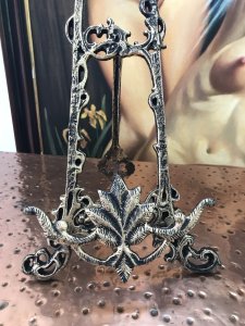 Pair Of Ornate Decorative Cast Iron Easels Stunning Fairy And Cherub Ornamental Top With Decorative Vines Decorative 3 Legged Stand With Pendulum Style Back Leg On Chain Decorative Acanthus Leaf Painting Holder Support Antiqued Gold Colouring Exceptional Heavy Quality Pieces For Table Top Displays Of Fine Arts Classical pictures not included Easels Approx 2kg In Weight Dimensions In Inches Height 47” Width 10.5” Depth 4.5”p