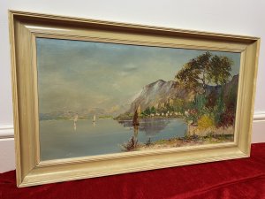 Italian Adriatic Coastal Landscape With Sail Boats Signed By Artist MONTE Circa - 20th Century Composition - Oil On Canvas Wonderfully Painted Impressionist Italian School Coastal Scene With Fabulous Perspective. In The Background A Rocky Mountain Range Is Painted In A Array Of Pastel Hues. The Artist Captures The Calm Bay With Many Italian Houses And Sailing Boats On The Water. A Striking Brightly Coloured Floral Display In The Forefront Of The Painting All In Complementing Colour Pallet. Signed By The Artist MONTE And Set in Cream Glaze Frame. Dimensions In Inches Height 20.5" Width 28 3/4"