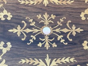 Antique Marquetry Inlaid Rosewood Jewellery/Sewing Casket Box C.1900 Circa - 1860 Composition - Rosewood Case Satinwood Inlay. Listing Description Beautiful Rosewood Sewing/Jewellery Casket With Fine Quality Floral Inlays On The Top And Front Elevations Of The Box. The Lid Of The Box Decorated With Leaves And Ornate Floral Sprays. In The Centre A Intricate Cartouche. The Front Of The Box Also With Rose Cartouche Around The Lock And Floral Sprays Surrounding. Exceptional Handcrafted Inlays In Satinwood. The Box Interior Has A Satin Covered Lift Out Compartmental Shelf, Which RevealsThe Casket Base With Extra Storage. Lovely Original Condition/ No Key Many Uses For Jewellery/ Charms/ Trinkets/ Sewing/ Crafting/ Keys/ Any Luxury Storage. Dimensions In Inches Height 4 1/4” X Width 11” X Depth 7 1/4”