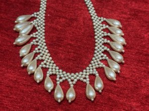 Antique Art Deco Teardrop and Seed Pearl Necklace With Silver Clasp Circa - 1920 Composition - Seed And Tear Drop Shaped Pearls Listing Description Stunning Feminine Antique Pearl Necklace Which Falls Into Teardrop Pearls Around Chest Line. Fair Condition Showing Signs of Wear Due to Age. Hangs 22cm In Length From Clasp When Closed.