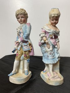 Rare Pair Of French Bisque Figurines The Prince And Princess With The Glass Slipper Circa - Vintage Composition - Bisque Hard Paste Porcelain Listing Description Beautiful Pair Of French Young Royal Male & Female Figurines. The Young Prince (Prince Charming) In Pale Blue/ Pink Tail Coat With Elaborate Neck Ruffle, Hand Painted Floral Sprays And Yellow 3/4 Pantaloons Holds A Ladies Slipper. The Young Lady (Cinderella) Wears Beautiful Pale Pink Corseted Bustier Dress With Full Skirt In Pale Blue Holding Her Foot Upon A Cushion Waiting To Try On The Slipper The Prince Is Holding. Stunning Facial Details And Attention To Detail. Condition - Vintage Used Minor Cracks To Porcelain Visible Please See Images, Wear To Pastel Glaze In Smem Parts Due To Age And Usage. Dimensions In Inches Height 12" Width 4.5" Depth 4"