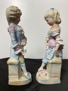 Rare Pair Of French Bisque Figurines The Prince And Princess With The Glass Slipper Circa - Vintage Composition - Bisque Hard Paste Porcelain Listing Description Beautiful Pair Of French Young Royal Male & Female Figurines. The Young Prince (Prince Charming) In Pale Blue/ Pink Tail Coat With Elaborate Neck Ruffle, Hand Painted Floral Sprays And Yellow 3/4 Pantaloons Holds A Ladies Slipper. The Young Lady (Cinderella) Wears Beautiful Pale Pink Corseted Bustier Dress With Full Skirt In Pale Blue Holding Her Foot Upon A Cushion Waiting To Try On The Slipper The Prince Is Holding. Stunning Facial Details And Attention To Detail. Condition - Vintage Used Minor Cracks To Porcelain Visible Please See Images, Wear To Pastel Glaze In Smem Parts Due To Age And Usage. Dimensions In Inches Height 12" Width 4.5" Depth 4"
