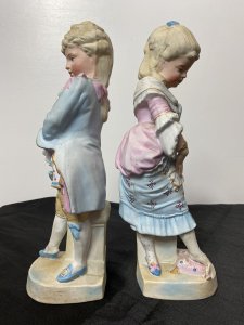 Rare Pair Of French Bisque Figurines The Prince And Princess With The Glass Slipper Circa - Vintage Composition - Bisque Hard Paste Porcelain Listing Description Beautiful Pair Of French Young Royal Male & Female Figurines. The Young Prince (Prince Charming) In Pale Blue/ Pink Tail Coat With Elaborate Neck Ruffle, Hand Painted Floral Sprays And Yellow 3/4 Pantaloons Holds A Ladies Slipper. The Young Lady (Cinderella) Wears Beautiful Pale Pink Corseted Bustier Dress With Full Skirt In Pale Blue Holding Her Foot Upon A Cushion Waiting To Try On The Slipper The Prince Is Holding. Stunning Facial Details And Attention To Detail. Condition - Vintage Used Minor Cracks To Porcelain Visible Please See Images, Wear To Pastel Glaze In Smem Parts Due To Age And Usage. Dimensions In Inches Height 12" Width 4.5" Depth 4"