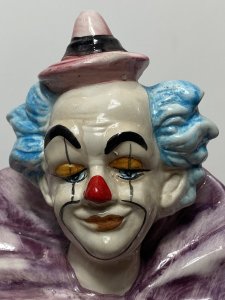 Magnificent Large Capodimonte Bright Glazed Circus Clown Figurine With Dog Companion. Circa - Vintage Composition - Glazed Porcelain Listing Description Large Stylised Hand Painted Circus Clown With Bold Face Paint, Blue Tufted Hair And Pointed Pink Hat. Oversized Double Flounced Neck Ruff Over Vibrant Yellow Spotted Coat. Orange Baggy Trouser With Comical Teared Hole At The Knee. This Magnificent Clown Holds Green Ball And Bugle Horn. A Fellow Dog Companion Sits Poised Upon The Circular Base With Blue Collar And Matching Hat. Wonderful Rare Piece For Collector Of Clowns \ Capodimonte And Circus Memorabilia. Condition - Used Sadly The Top Of The Bugal Has Been Damaged Please See Images. A Few Small Chips To Paint Visible Due To Age And Usage. This Does Not Detract From The Beauty Of The Piece But Is Reflective In The Price. Dimensions In Inches Height 20" Width 9" Depth 10"