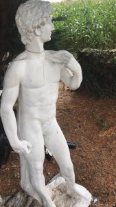 Roman Male Statue In Classical Pose Italian Style Tall And Handsome Composition- Weathered Reconstituted Stone Dimensions In Inches Height 46” Width 16” Depth 15”