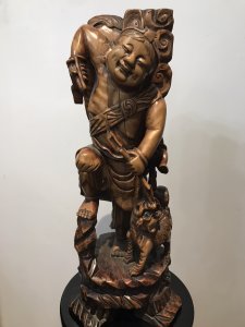 Late 19th Century Oriental Chinese Foo Man Sculpture Carved In Fruitwood Chinese Huntsman With Foo Dog Standing Upon Plinth With 4 Carved Feet Both With Glass Radiant Eyes Amazing Quality And Detail Exceptionally Well Executed Hand Carving Out Of One Piece Of Rare Wood Unsigned Collectors Item Circa - 1875 Dimensions In Inches Height 23” Width 9” Weight Approx 10kg