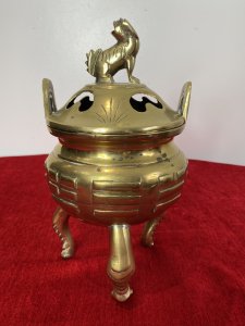 Chinese Qing Style 19th Century Insense Burner With Foo Dog Lid. Bulbous Shaped Incense Pot With Geometric Shaped Decoration Stands Upon Crab Like Tripod Legs. Loop Handles And Heavy Lid With Smoke Holes And Foo Dog Pinnacle With A Hole Mouth For Incense Smoke Deploy. Beautiful Quality Incense Burner In Unusual Form. Unsigned. Quality Collectors Piece. Dimensions In Inches Height 10” Width 5 1/4 “