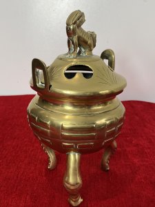 Chinese Qing Style 19th Century Insense Burner With Foo Dog Lid. Bulbous Shaped Incense Pot With Geometric Shaped Decoration Stands Upon Crab Like Tripod Legs. Loop Handles And Heavy Lid With Smoke Holes And Foo Dog Pinnacle With A Hole Mouth For Incense Smoke Deploy. Beautiful Quality Incense Burner In Unusual Form. Unsigned. Quality Collectors Piece. Dimensions In Inches Height 10” Width 5 1/4 “
