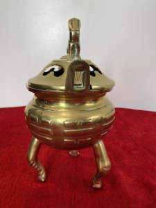 Chinese Qing Style 19th Century Insense Burner With Foo Dog Lid. Bulbous Shaped Incense Pot With Geometric Shaped Decoration Stands Upon Crab Like Tripod Legs. Loop Handles And Heavy Lid With Smoke Holes And Foo Dog Pinnacle With A Hole Mouth For Incense Smoke Deploy. Beautiful Quality Incense Burner In Unusual Form. Unsigned. Quality Collectors Piece. Dimensions In Inches Height 10” Width 5 1/4 “