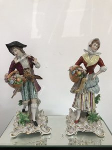 Pair Of 18th Century Style Chelsea Figurines. Lady And A Gentleman Gathering Fruit And Game Standing On Shaped Gilded Plinths. Painted In Bright Hues. The Detail On These Figurines Is Breathtaking. Chelsea Markings On The Bases. Slight Damage On The Gentleman’s Forefinger. Provenance: Purchased From The Lord Hill Museum Shropshire. Dimensions In Inches. Height 7 1/4”. Base 3” Square