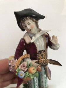 Pair Of 18th Century Style Chelsea Figurines. Lady And A Gentleman Gathering Fruit And Game Standing On Shaped Gilded Plinths. Painted In Bright Hues. The Detail On These Figurines Is Breathtaking. Chelsea Markings On The Bases. Slight Damage On The Gentleman’s Forefinger. Provenance: Purchased From The Lord Hill Museum Shropshire. Dimensions In Inches. Height 7 1/4”. Base 3” Square