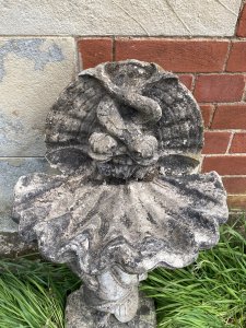 Classical Cherub Holding Scallop Shell Basin With Dolphins Bird Bath. Circa - Vintage Composition- Reconstituted Stone Condition- Used Original Weathered Beautifully Detailed Cherub Stands Against Scrolled Column Carefully Balancing A Scallop Shell Basin Above His Head With Ornamental Dolphins Fountain Design. Refined Facial Features With Eloquent Hands. An Exceptional Vintage Piece Inspired By French 18th Century Architecture. Stunning Garden Feature For Attracting Birds And Wildlife. Heavy Item. Provenance Purchased From 18th Century Stately Home Walled Market Garden, Derby. Dimensions In Cms Height 86cm Width 42cm Depth 29cm