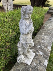 Classical Young Georgian Aristocrat Nobleman Garden Sculpture. Young Aristocratic Gentleman In The Georgian Style Wears Long Buttoned Coat, Shorts And Laced Up Boots. The Young Male Holding Coat Closed At The Top Make Him Look Mischievous. Beautifully Sculpted Fabric Movement. Lovely Facial Details. Vintage Piece. Dimensions In Inches Height 28” Width 10” Depth 9” Weight Approx 40KG