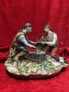 Large Italian Capodimonte Porcelain Figurine 'The Pirates Hidden Treasure' Signed By Artist Circa - 1940 Composition - Hard Paste Porcelain Listing Description Highly Renowned Capodimonte Collectable Showpiece. This Rare Subject Is An Exceptional Capodimonte Specimen. The Fine Quality Evident From The Realism Captured In The Finer Details Including; Faces, Hands, Fabric Movement In Clothes As Well And The Surrounding Flora And Fauna, Just To Name A Few. The Figure Depicts Two Pirates During Their Moment Of Discovery Opening A Large Wooden Treasure Chest, Cascading With Gold, Pearls And Precious Stones. One Of The Pirates Has A Metal Claw As A Hand, Exactly As You Would Expect Of A Pirate! The Treasure Map And Pick Axe A Foot Whilst They Glaze At The Prize. Signed By Artist. True Capodimonte Collectors Figurine. Dimensions In Cms Height 22cm X Width 29cm X 24 Depth For Further Information Please Enquire Direct On 07707 488566 Thank-you