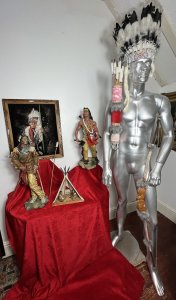 Mesmerising Collection Of Native American ' Big Chief Sitting Bull' Memorabilia Circa - Vintage Composition - Mixed Materials *Head Dress - Calf Skin, Axe Figure - Resin, Bow & Arrows - Wood Mixed Media, Tipi - Wood & Resin Figures, Paintin - Velvet Canvas Wood Frame.* Listing Description Thought Provoking Collection Of Native American Big Chief Sitting Bull Memorabilia. Six Piece Set Includes Warbonnet Head Dress In Calf Skin With Decorative Beaded Edge, Animal Pelts And Large Plumes Of Feathers. Indian Chief Painting On Velvet Set In Ornate Carved Wood Frame. A Decorative String Bow With Carved Wood Chief Handle And String Line, Matching Decorated Cylindrical Holster With Wood Arrows (Bow And Arrows For Decoration Only). An Interesting Wooden Tipi Sculpture With Internal Sitting Chief And Squaw With Holster Of Arrows, A Charming Peeping Hole In The Back Of Tipi Gives it Great Interest. Large Native Indian Figure With Axe In Tradition Native Clothing. * Native Indian With Bow Figurine not Included With Set * Wonderful Set For Collector Of Tribal Memorabilia Or Use As Props. Provenance Purchased From Avid Collector Of Chief Sitting Bull Memorabilia, And Now Part Of Private Lord Hill Museum Collectoion. Dimensions in Inches Painting Height 22 3/4 X Width 18 3/4 Tipi Height Height 13 1\4 X Width 10.5" X Depth 5 1/4 Axe Figure Height 24" X Width 12" X Depth 14" Bow Height 53" X Width 8" X Depth 2" Arrows Height 26" X Width 8" x Depth 2" Warbonnet Head Dress Height 31" X Width 23" X Depth 16"