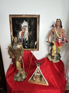 Mesmerising Collection Of Native American ' Big Chief Sitting Bull' Memorabilia Circa - Vintage Composition - Mixed Materials *Head Dress - Calf Skin, Axe Figure - Resin, Bow & Arrows - Wood Mixed Media, Tipi - Wood & Resin Figures, Paintin - Velvet Canvas Wood Frame.* Listing Description Thought Provoking Collection Of Native American Big Chief Sitting Bull Memorabilia. Six Piece Set Includes Warbonnet Head Dress In Calf Skin With Decorative Beaded Edge, Animal Pelts And Large Plumes Of Feathers. Indian Chief Painting On Velvet Set In Ornate Carved Wood Frame. A Decorative String Bow With Carved Wood Chief Handle And String Line, Matching Decorated Cylindrical Holster With Wood Arrows (Bow And Arrows For Decoration Only). An Interesting Wooden Tipi Sculpture With Internal Sitting Chief And Squaw With Holster Of Arrows, A Charming Peeping Hole In The Back Of Tipi Gives it Great Interest. Large Native Indian Figure With Axe In Tradition Native Clothing. * Native Indian With Bow Figurine not Included With Set * Wonderful Set For Collector Of Tribal Memorabilia Or Use As Props. Provenance Purchased From Avid Collector Of Chief Sitting Bull Memorabilia, And Now Part Of Private Lord Hill Museum Collectoion. Dimensions in Inches Painting Height 22 3/4 X Width 18 3/4 Tipi Height Height 13 1\4 X Width 10.5" X Depth 5 1/4 Axe Figure Height 24" X Width 12" X Depth 14" Bow Height 53" X Width 8" X Depth 2" Arrows Height 26" X Width 8" x Depth 2" Warbonnet Head Dress Height 31" X Width 23" X Depth 16"