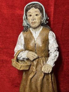Charming Studio Pottery Figurine 'Lady Holding Egg Basket' Sculpture Circa - Vintage Composition - Ceramic/ Clay Listing Description Beautiful Collectors Studio Pottery Figuring Depicting Lady In Powder Blue Headscarf Holding Basket Laden With Eggs. Hand Crafted Pottery Intricately Detailed Sculpture. Astonishingly Sculpted Facial Features And Beautifully Crafted Hands Holding Wicker Egg Basket, Wearing Two Piece Botton Front Waistcoat With Matching Floor Length Skirt And Glossy Broderie Anglaise Shirt. Unsigned Dimensions In Inches Height 17" X Width 7" x Depth 7" For Further Information Please Call 07376 618513 Thank-you