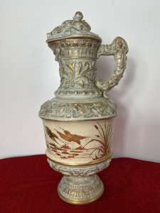 French Antique Classical Wine Ewer Decorated With Gilt Mural Of Herons. Circa ~ 1890 Large Pale Blue Ewer Urn Decorated In Grape Vines With Gilt Painted Mural Of Flying Herons With Salt Reeds Around The Centre. Beautifully Ornate Gilt Rams Head Handle With Masked Head Spout And Stunning Unusual Hogs Head Lid. Sits Upon Gilt Circular Base With Symmetrical Bulbous Floral Patternation. No Makers Mark But Stunning Details Quality Museum Grade Piece. Condition- Antique Used Small Top Pinnacle Seems To Be Missing From Lid Top. Otherwise Beautiful Condition Shows Signs Of Age In The Glaze Conducive To Age And Usage. Provenance Part Of Large Paris Private Collectors Exhibition. Now Showcased At Lord Hill Museums Extensive Collection. Dimensions In Inches Height 18.5” Width Widest Point 8” Weight Approx 8Kg