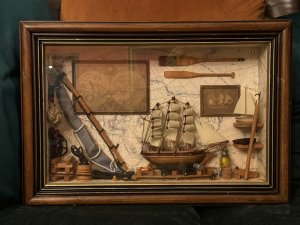 Vintage Maritime Nautical Sailing Ships Chandler Diorama/Shadowbox Circa - Vintage Composition - Wood/ Mixed Media Listing Description Wonderful Quality Detailed Sailing Ships Chandler Diorama Wall Hanging. Glazed Wooden Shadowbox With Wood Frame Showcasing A Backdrop Of World Map With Hanging Pictures Of Sailing Ship, Map Of The World And Wood Paddles. Central Large Sailing Ship Model Set Upon Blocks, With Surrounding Life Ring, Hammer, Bucket And Lantern. To The Right Side Of Model Is Shelving With Various Ship Model And Left Side Of Model Large Resting Ships Sail, Bucket Of Rope And Hanging Rope Buoy. Interesting Handmade Collectors Item. Dimensions In CMS Height 30cm X Width 35cm X Depth 6.5cm For Further Information Please Call The Museum Curator On 07707 488566 Thank-you.