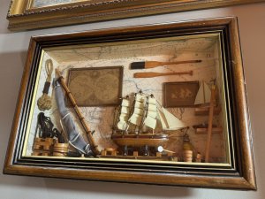Vintage Maritime Nautical Sailing Ships Chandler Diorama/Shadowbox Circa - Vintage Composition - Wood/ Mixed Media Listing Description Wonderful Quality Detailed Sailing Ships Chandler Diorama Wall Hanging. Glazed Wooden Shadowbox With Wood Frame Showcasing A Backdrop Of World Map With Hanging Pictures Of Sailing Ship, Map Of The World And Wood Paddles. Central Large Sailing Ship Model Set Upon Blocks, With Surrounding Life Ring, Hammer, Bucket And Lantern. To The Right Side Of Model Is Shelving With Various Ship Model And Left Side Of Model Large Resting Ships Sail, Bucket Of Rope And Hanging Rope Buoy. Interesting Handmade Collectors Item. Dimensions In CMS Height 30cm X Width 35cm X Depth 6.5cm For Further Information Please Call The Museum Curator On 07707 488566 Thank-you.