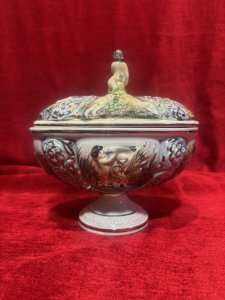 Capodimonte Ornamental Putti & Floral Spray Lidded Vase Maker - Stamped Capodimonte Composition - Porcelain Listing Description Capodimonte Porcelain Lidded Jardiniere Vase. All Sides Depicting Detailed Relief Scenes Of Cherub Figures With Shells Near The Waters Edge Surrounded By Floral Sprays, Vibrant Colour Palette With Excessive Gilt Work. Maker Stamp Capodimonte Numbered 238 On Base. Pristine Condition. Dimensions In Cms Height 21.5cm x Width 22cm X Depth 16cm