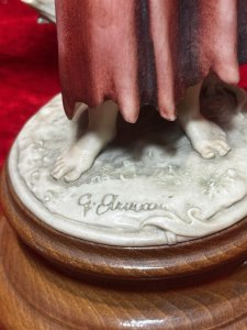 Giuseppe Armani Capodimonte Pair Boy & Girl Fruit Bearer Figurines Wooden Base Circa -1982 Composition - Resin/ Wood Base Listing Description Pair Of Decorative Capodimonte Figurines Depicting Young Man and Lady Carrying Large Basket Of Fruit. Signed By Artist Giuseppe Armani And Foundry Stamped. Set On Circular Wood Plinth Bases. Dimensions In Cms Height 20cm X Width 14cm X Depth 15cm