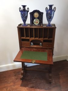 Fine Victorian Sheritan Style Escritoire On Stand Solid Mahogany With Satinwood String Inlays And Classical Shell Motif Design Ornate Brass Gallery Around The Top Brass Carry Handles On The Side Panels The Drop Down Front Reveals Pigeon Holes, Two Drawers, Ink Well Compartments And Pen Placement Four Sabre Shaped Feet With Brass Castor Feet For Ease Of Movement Handmade By English Cabinet Maker But Unsigned Rare Writing Cabinets Like This Were Sometimes Used By Sea Captains Aboard Ships Please Note This Is A Antique Piece And Has Some Signs Of Wear Conductive To Age And Usage One Of The Side Handles Is Missing, There Are Minor Cracks In The Woodwork And Minor Marks On The Felt Writing Top Please See All Pictures Dimensions In Inches Height 481/4” Width 27” Depth 18”