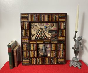 Decorative American Pool Library Setting Diorama Wall Display Collectors Piece. Rudolf Walter Wonderone Style Wonderfully Detailed American Pool Themed Diorama Display With Refrence Library Books Shelf Surround In Mahogany Frame. Central Top Shelf Displays American Pool Balls Set In Triangle, Resting Pool Que , Chalk, Wax And Que Rest On Decorative Pool Players Paper Cutting Montage Background. Bottom Shelf With American Pool Champion Trophy With Pool Player Pictures Montage Background. Craftsman Made Piece In Solid Carved Wood. Metal Hanging Hooks For Wall Hanging On Reverse. Exceptional Piece For Gentleman’s Room/ Man Cave Display. Highly Decorative Rare Reproduction Piece In Stunning Condition. Dimensions In Inches Height 21 3/4” Width 18.5” Depth 1 1/4”