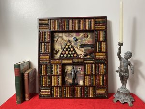Decorative American Pool Library Setting Diorama Wall Display Collectors Piece. Rudolf Walter Wonderone Style Wonderfully Detailed American Pool Themed Diorama Display With Refrence Library Books Shelf Surround In Mahogany Frame. Central Top Shelf Displays American Pool Balls Set In Triangle, Resting Pool Que , Chalk, Wax And Que Rest On Decorative Pool Players Paper Cutting Montage Background. Bottom Shelf With American Pool Champion Trophy With Pool Player Pictures Montage Background. Craftsman Made Piece In Solid Carved Wood. Metal Hanging Hooks For Wall Hanging On Reverse. Exceptional Piece For Gentleman’s Room/ Man Cave Display. Highly Decorative Rare Reproduction Piece In Stunning Condition. Dimensions In Inches Height 21 3/4” Width 18.5” Depth 1 1/4”