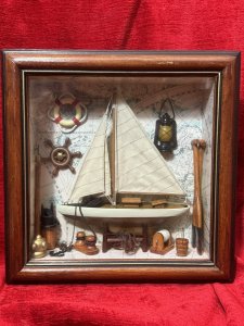 CHARMING VINTAGE SAILING BOAT MARINE DIORAMA IN DISPLAY CASE Circa - 1980 Composition - Wood And Mixed Media Listing Description Wonderful Vintage Sail Boat Diorama Model Set Inside Glazed Mahogany Wood Frame. A Large Wooden Sail Boat Centre Of Display With Fabric Sails And Metal Anchor On Looped Chain. Intricate Background Of Antique Atlas Pages With Ornamental Wall Hangings Of Captains Oil Lamp, Life Ring, Ships Wheel Hanging As Wall Display. The Floor Display Of The Diorama Is Laden With Nautical Goodies including Wooden Sail Paddles, Bucket, An Abundance Of Rope And Rope Holders, Mooring Posts And Rope Hooking Pole. A Spectacular Model For Marine Enthusiasts. Dimensions in Cms Height 30cm x Width 30cm x Depth 8cm For Further Information Kindly Message Or Call The Museum Curator Leslie On 07707 488566. Thank-you