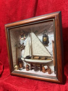 CHARMING VINTAGE SAILING BOAT MARINE DIORAMA IN DISPLAY CASE Circa - 1980 Composition - Wood And Mixed Media Listing Description Wonderful Vintage Sail Boat Diorama Model Set Inside Glazed Mahogany Wood Frame. A Large Wooden Sail Boat Centre Of Display With Fabric Sails And Metal Anchor On Looped Chain. Intricate Background Of Antique Atlas Pages With Ornamental Wall Hangings Of Captains Oil Lamp, Life Ring, Ships Wheel Hanging As Wall Display. The Floor Display Of The Diorama Is Laden With Nautical Goodies including Wooden Sail Paddles, Bucket, An Abundance Of Rope And Rope Holders, Mooring Posts And Rope Hooking Pole. A Spectacular Model For Marine Enthusiasts. Dimensions in Cms Height 30cm x Width 30cm x Depth 8cm For Further Information Kindly Message Or Call The Museum Curator Leslie On 07707 488566. Thank-you