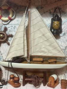 CHARMING VINTAGE SAILING BOAT MARINE DIORAMA IN DISPLAY CASE Circa - 1980 Composition - Wood And Mixed Media Listing Description Wonderful Vintage Sail Boat Diorama Model Set Inside Glazed Mahogany Wood Frame. A Large Wooden Sail Boat Centre Of Display With Fabric Sails And Metal Anchor On Looped Chain. Intricate Background Of Antique Atlas Pages With Ornamental Wall Hangings Of Captains Oil Lamp, Life Ring, Ships Wheel Hanging As Wall Display. The Floor Display Of The Diorama Is Laden With Nautical Goodies including Wooden Sail Paddles, Bucket, An Abundance Of Rope And Rope Holders, Mooring Posts And Rope Hooking Pole. A Spectacular Model For Marine Enthusiasts. Dimensions in Cms Height 30cm x Width 30cm x Depth 8cm For Further Information Kindly Message Or Call The Museum Curator Leslie On 07707 488566. Thank-you