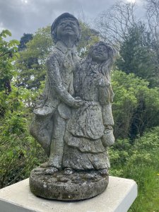 Vintage Jolly Farmer And His Wife Embracing Garden Statue. Circa - Vintage Composition- Reconstituted Stone Smartly Clothed Farming Gentleman Wearing A Flat Cap Holding The Hand Of His Wife Wearing Elaborate Frilled Gown. Smiling Faces With Lovely Details. Heavy Statue 20KG Approx Dimensions In Cms Height Width Depth