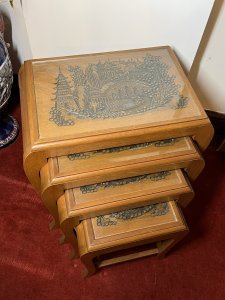 Oriental Teak Nest Of Four Tables With Mudiao Fretwork Temple Landscape Tops Circa - 1950 Composition - Teak Listing Description Set Of Four Elegant Oriental Rectangular Nesting Tables With Finely Carved Mudiao Fretwork Landscapes Under Protective Glass Tops. All Set Upon Sabre Legs With Support Stretchers. Each Table Diminishing In Size Has Oriental Village Scene With Ornate Native Trees, Elaborate Pagodas, Large Foot Bridge Over Water With Chinese Figures Crossing And Sampan Boat. Condition - Excellent Dimensions In Inches Largest Height 24.5" X Width 22" X Depth 13.5" Smallest Height 16.5" X Width13" X Depth 10.5"